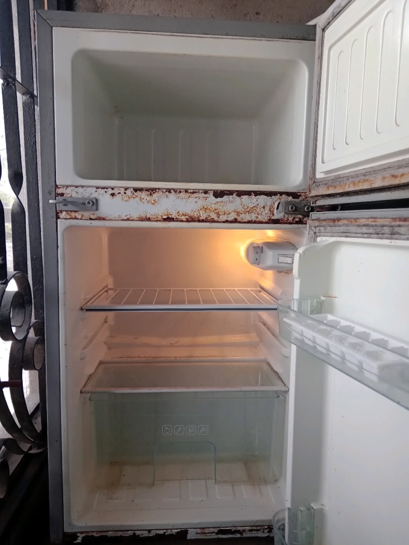 Old Two-Door Refrigerator with Internal Leakage